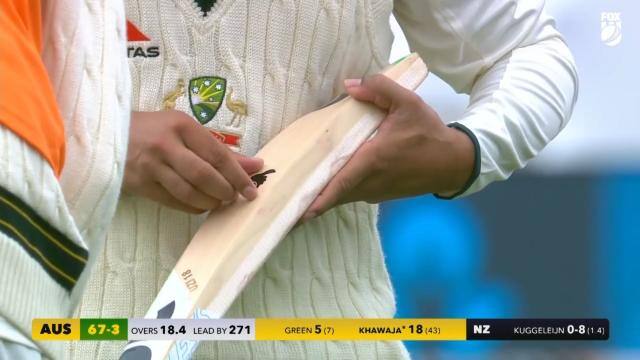 Usman Khawaja was forced to remove the dove logo on his bat [screengrab]