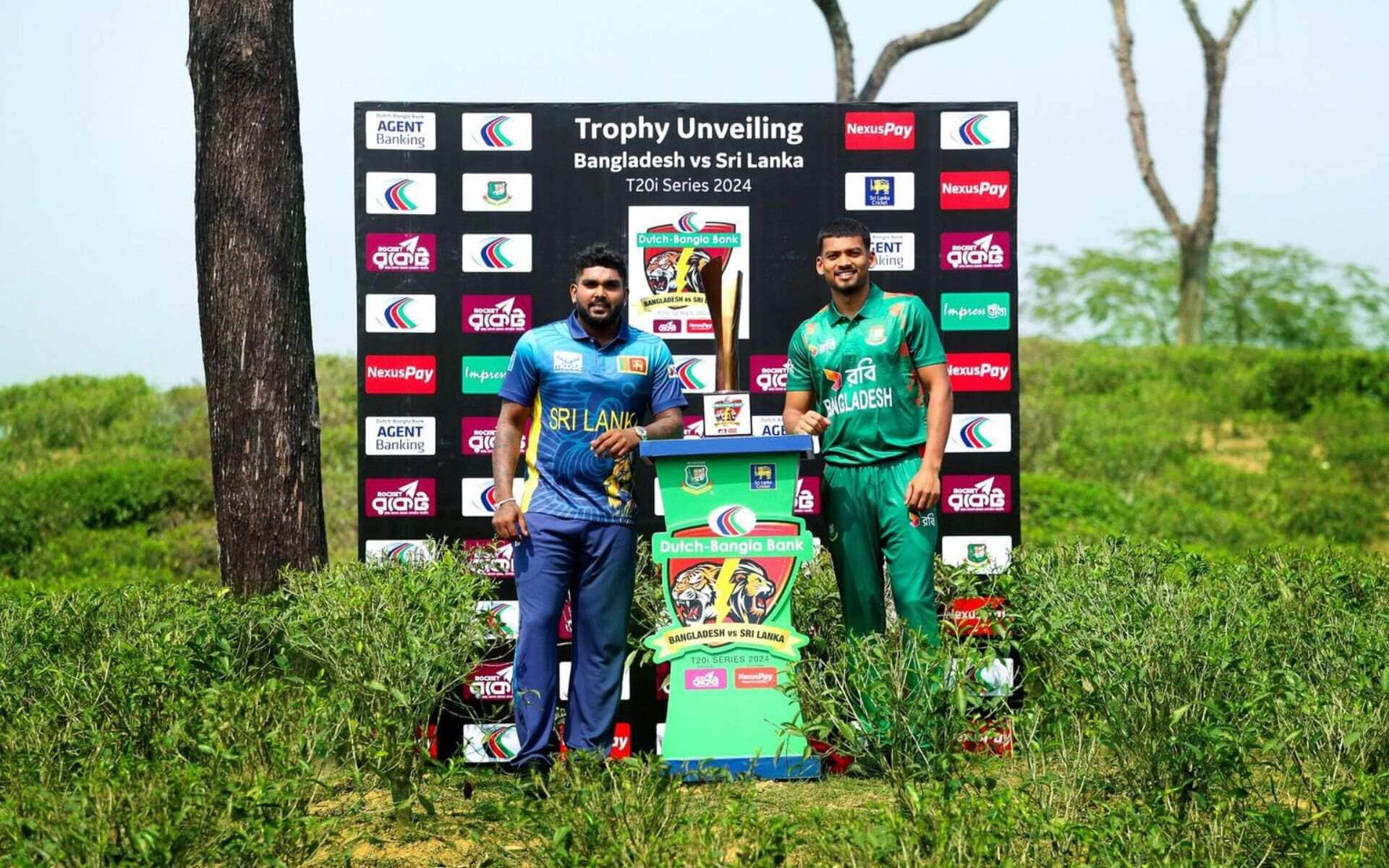 Hasaranga and Najmul Hossain Shanto posing with the trophy (X.com)