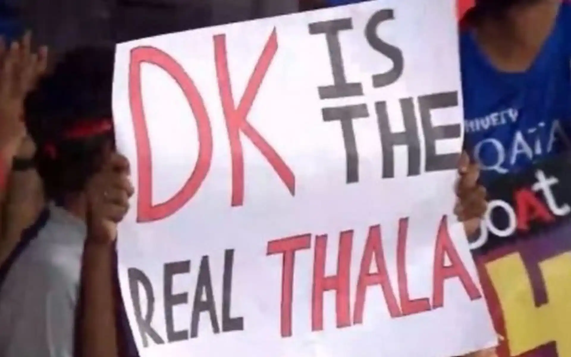 Dinesh Karthik fan holding a poster in favor of RCB wicketkeeper (x.com)