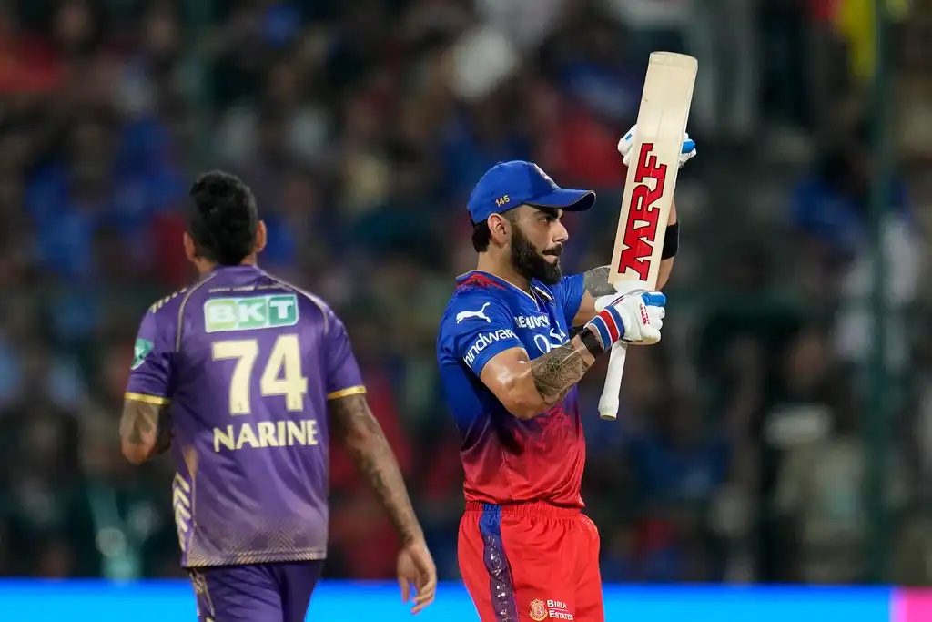 Kohli celebrating a shot off Narine's bowling (AP Photo)