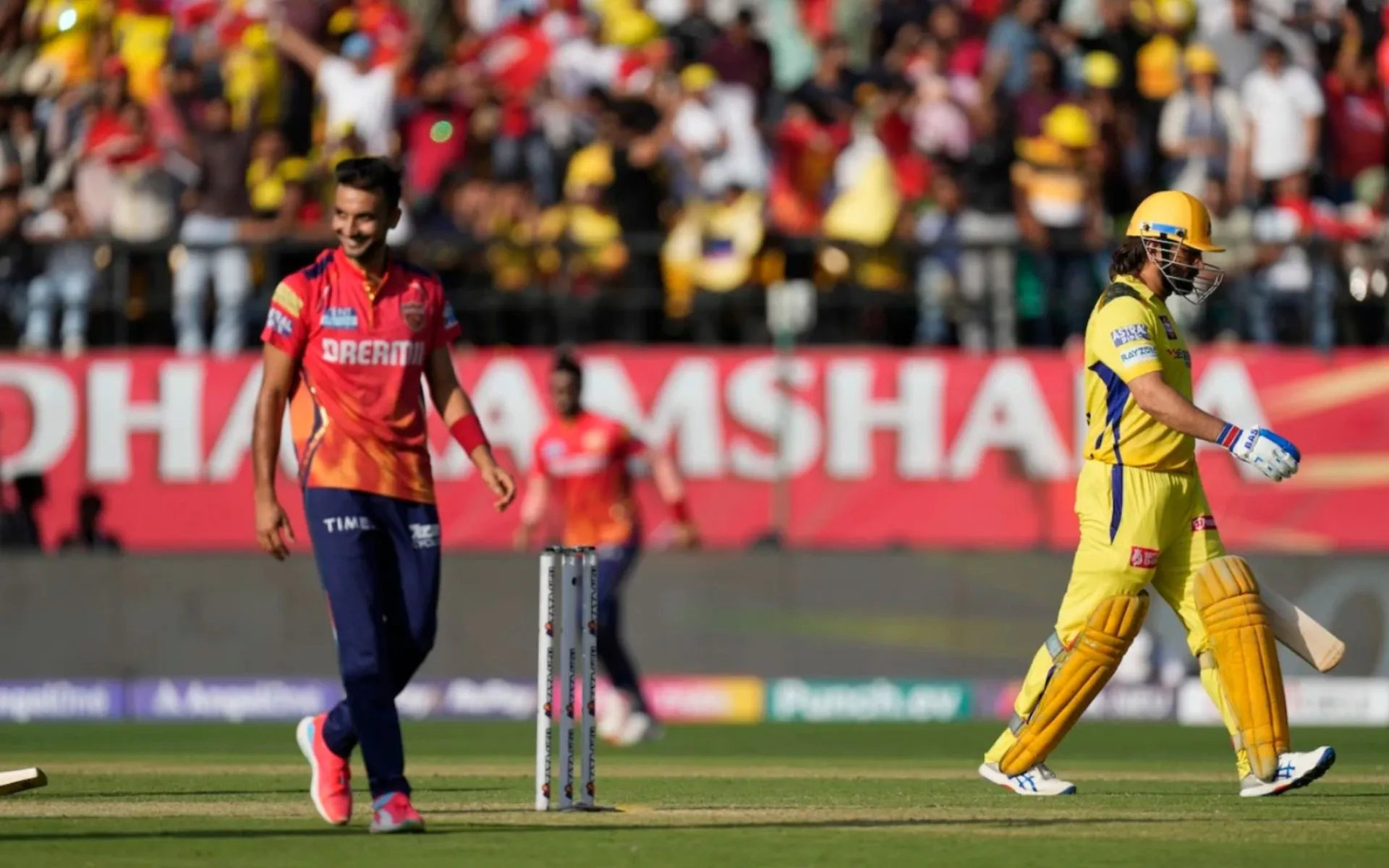 MS Dhoni walking off after getting deceived by Harshal Patel (AP)