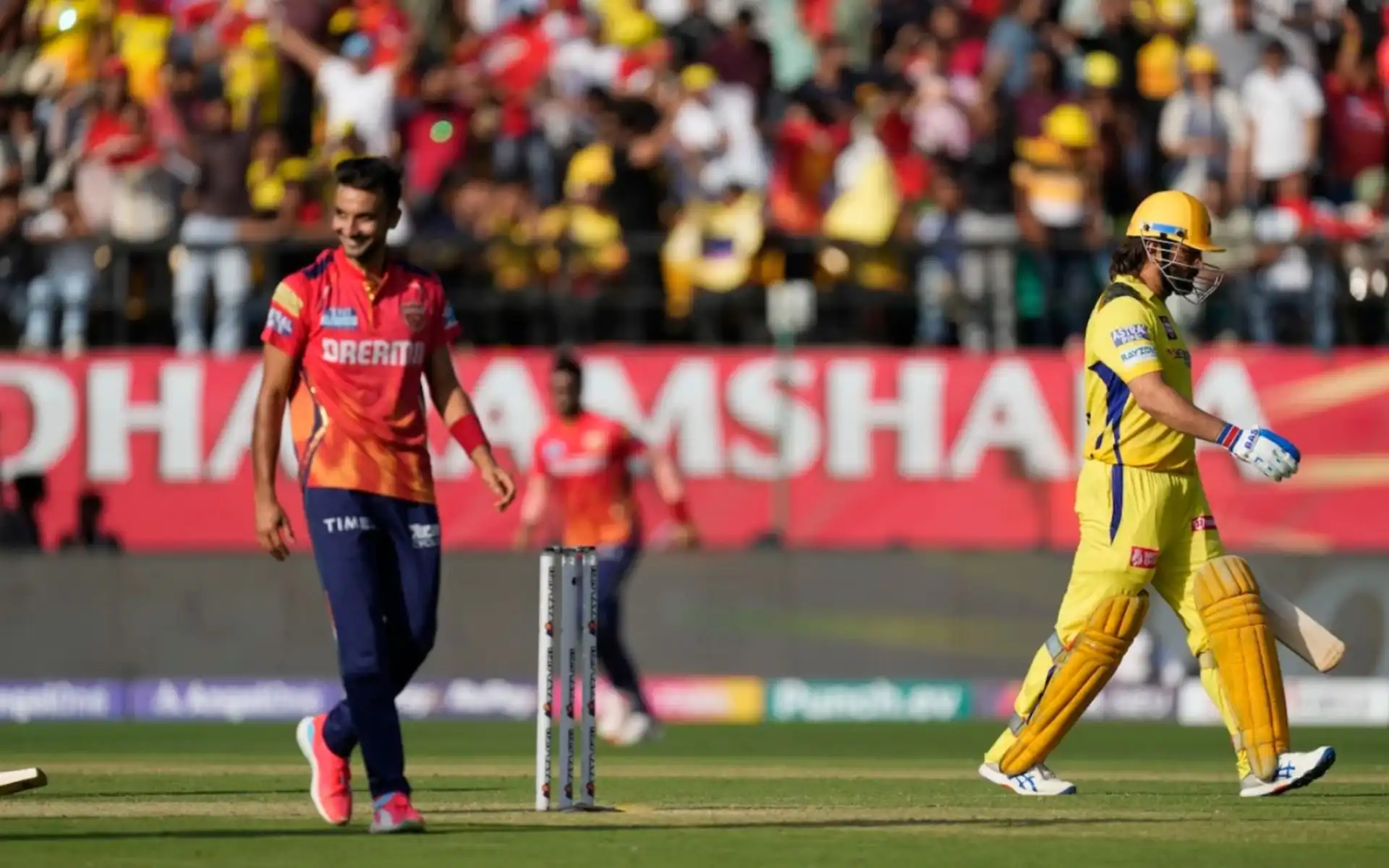 MS Dhoni walking off after getting deceived by Harshal Patel (AP)