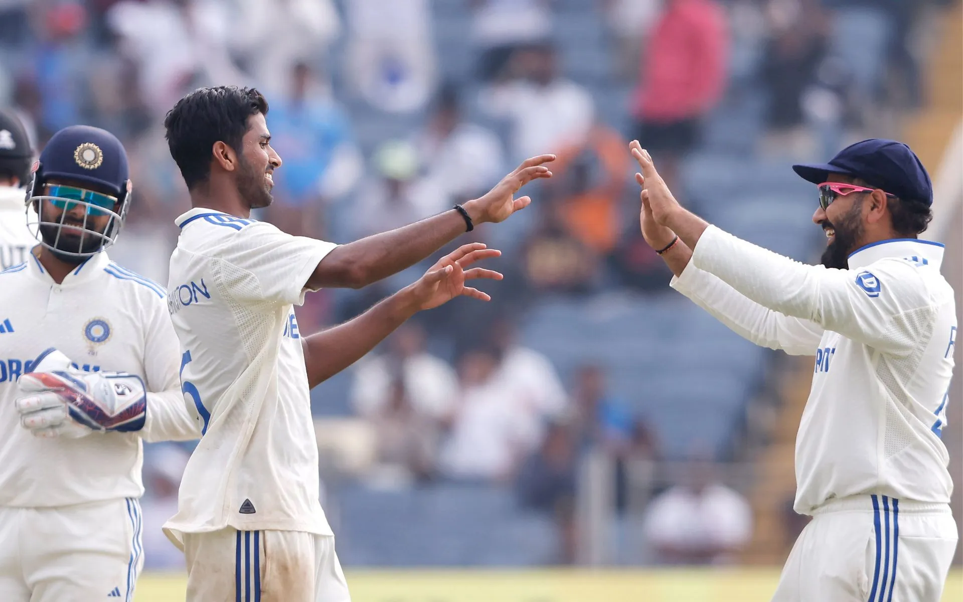 Washington Sundar celebrating a wicket with captain Rohit Sharma [Source: @BCCI/x]