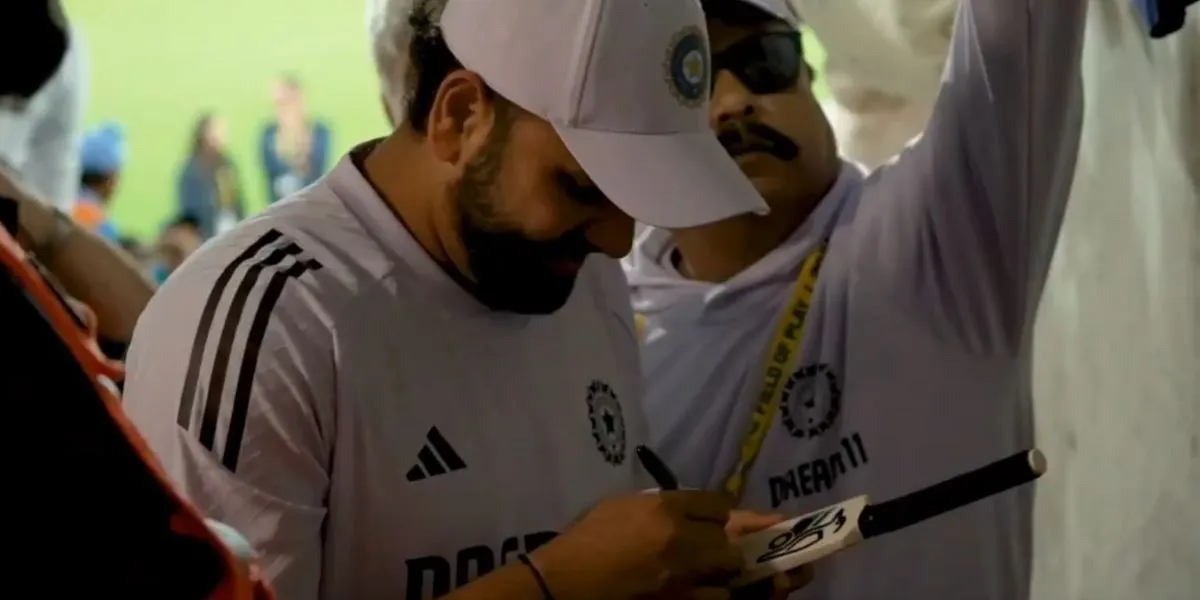 Rohit Sharma signed a lucky fan's miniature bat at Canberra [Source: @BCCI/X.com]