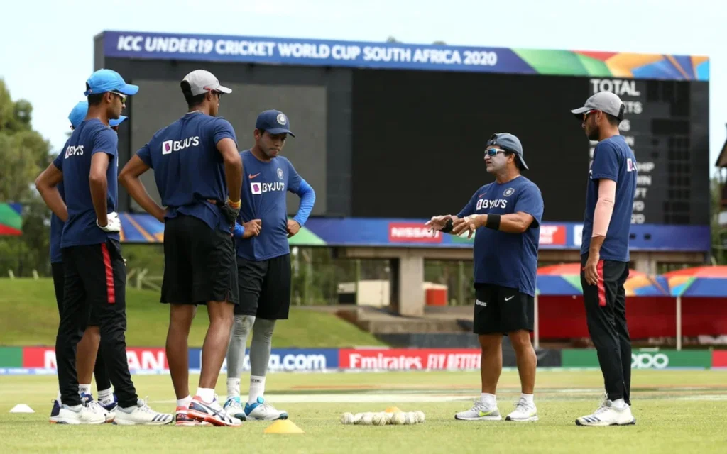 Abhay Sharma with India's Under-19 players [Source: @SpotOnEntertai1/x]