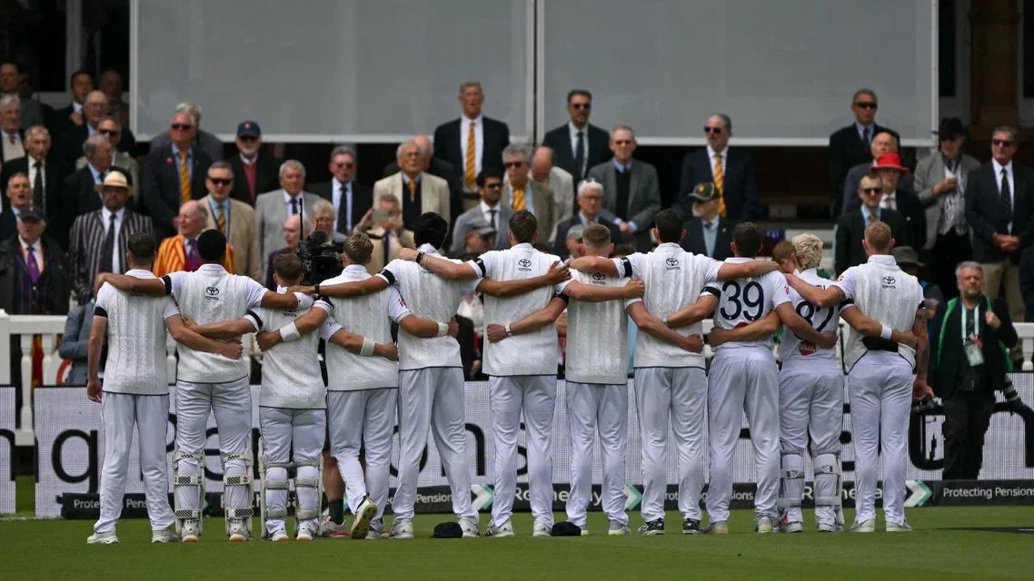 England players wearing black armbands. [Source - AFP]
