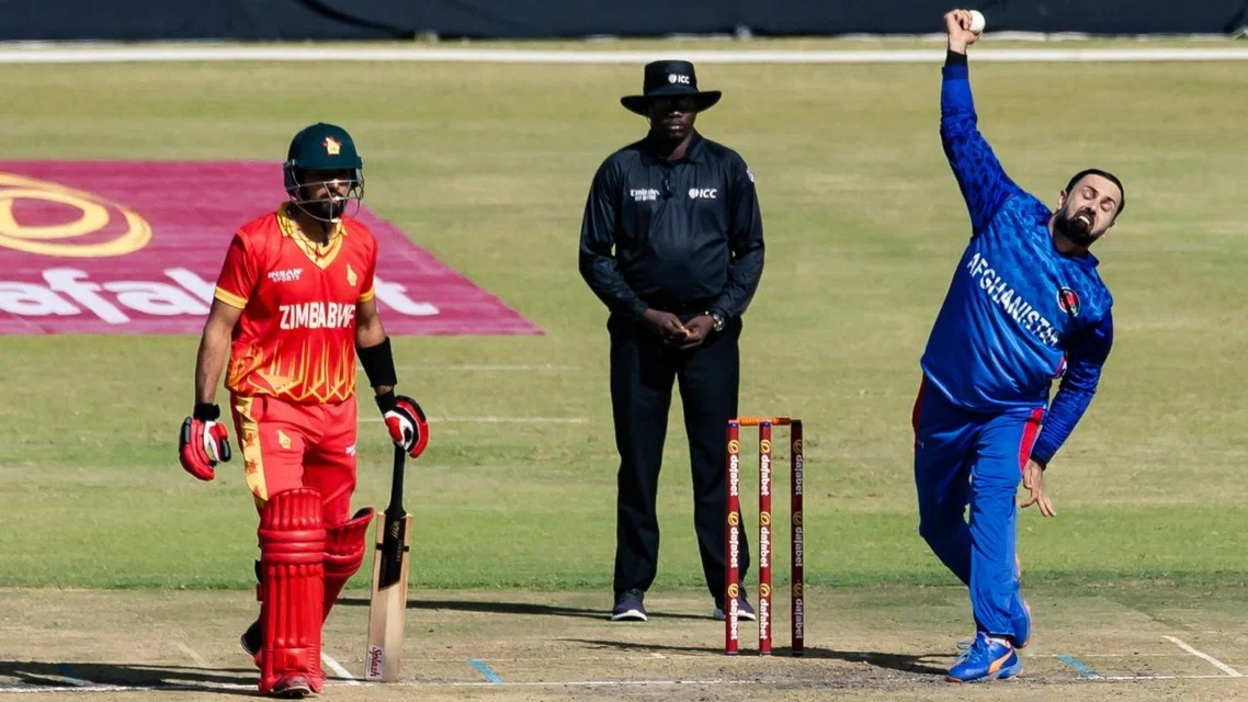 Mohammad Nabi bowling while Sikandar Raza at non-striker's end | AFP Photos